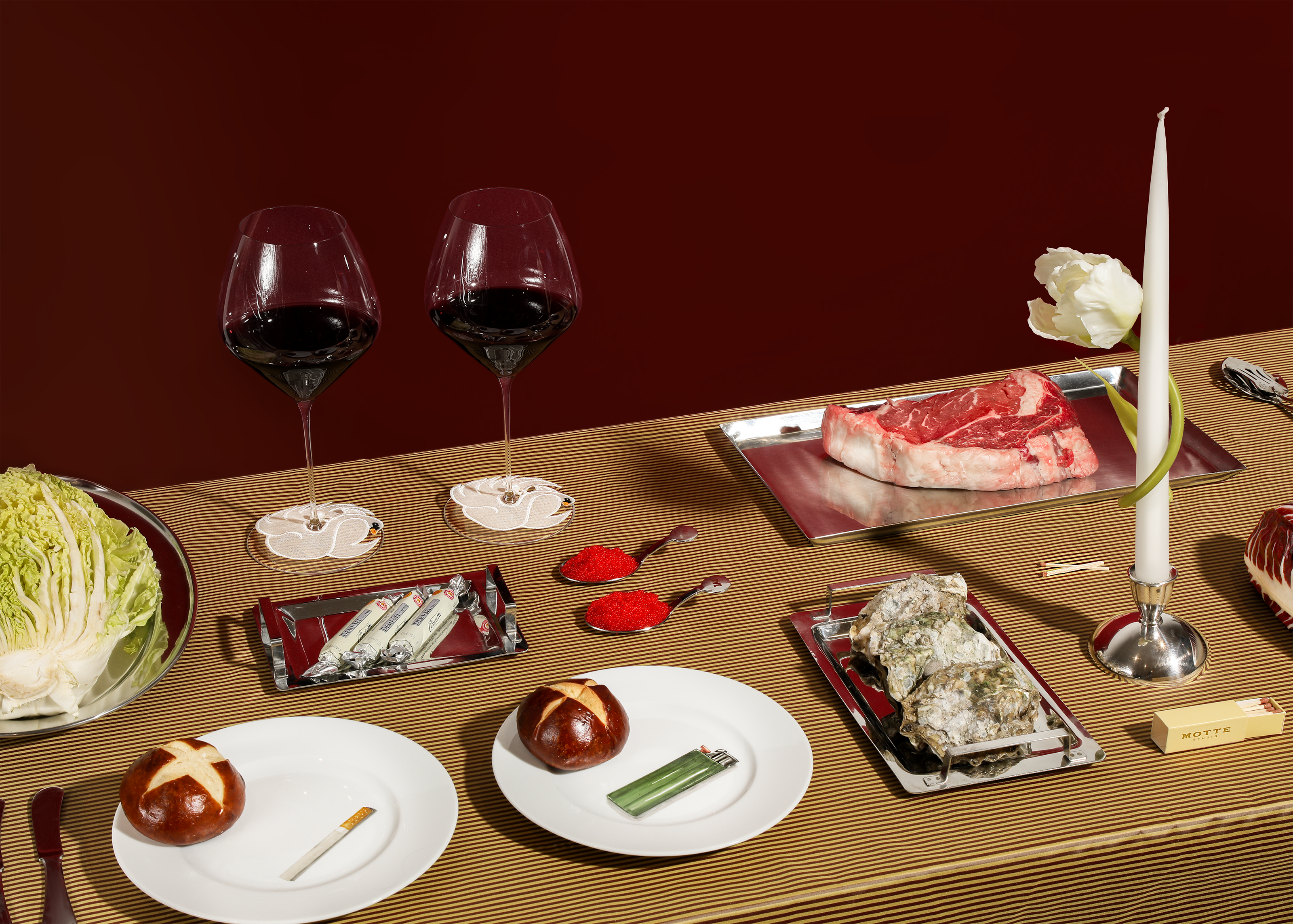 Luxe dining table set with plates wine and candle.